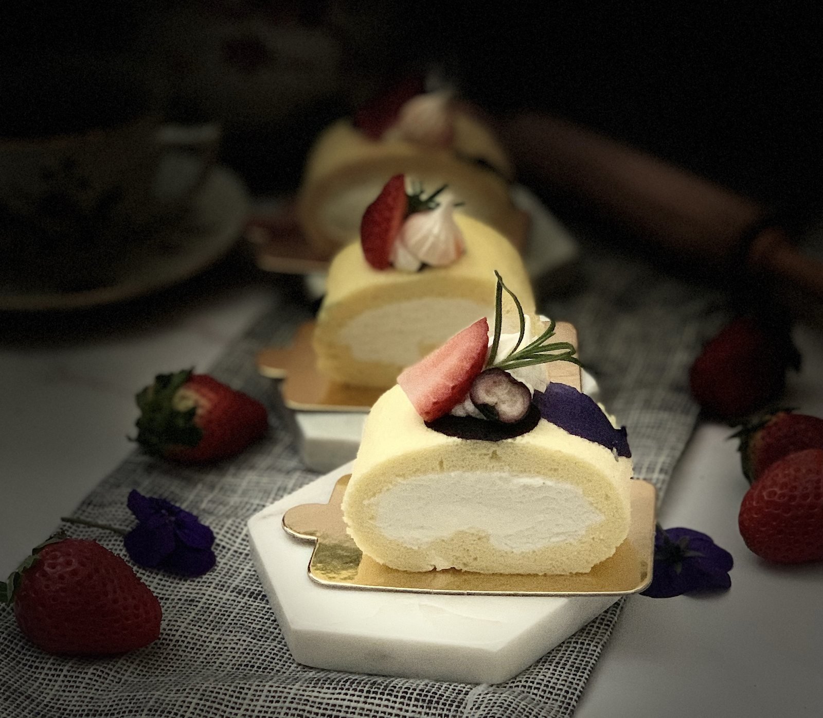 Vanilla cream cake roll topped with fresh strawberries